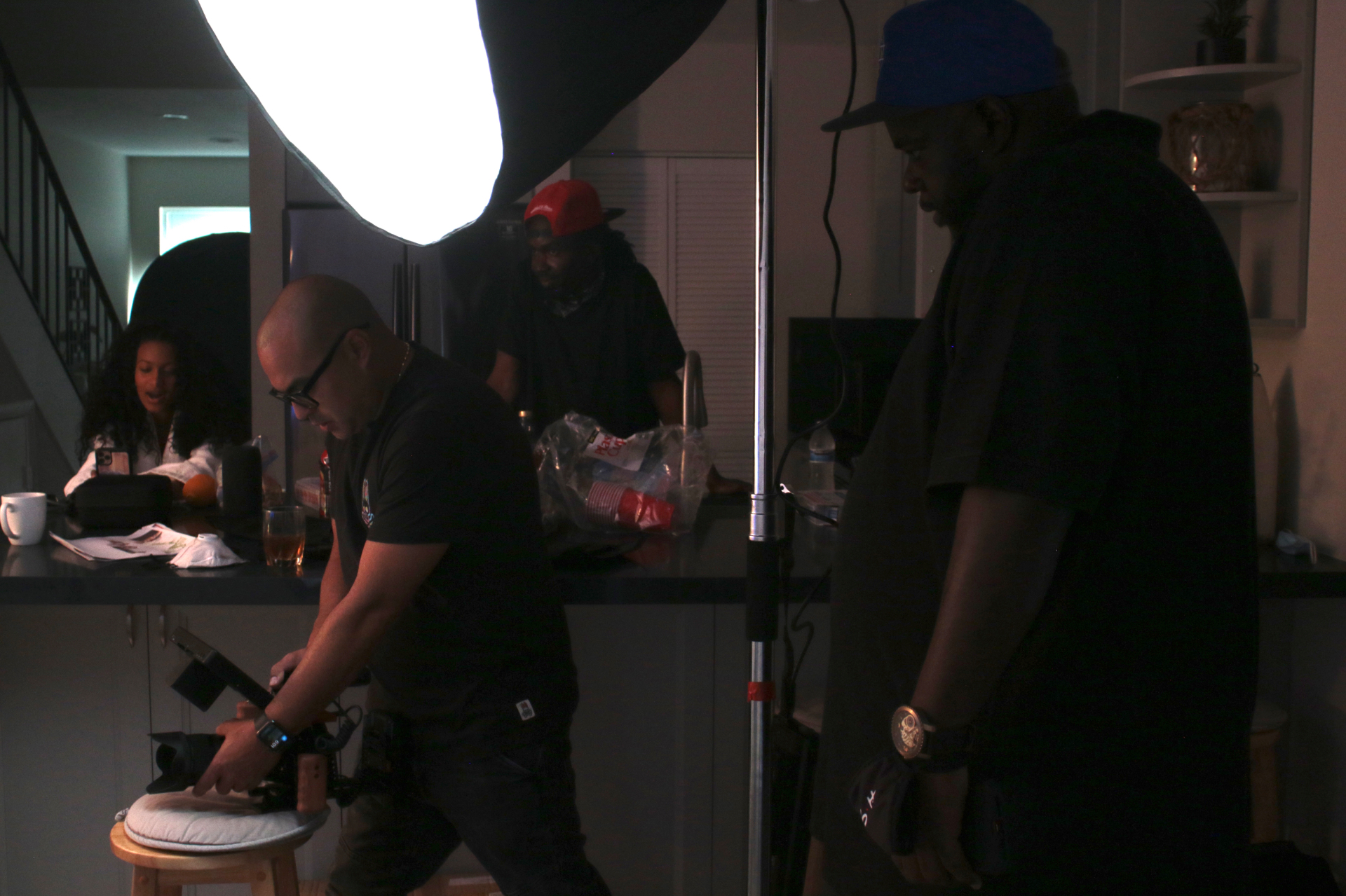 Overseeing a low-light interior lighting setup on a music video set