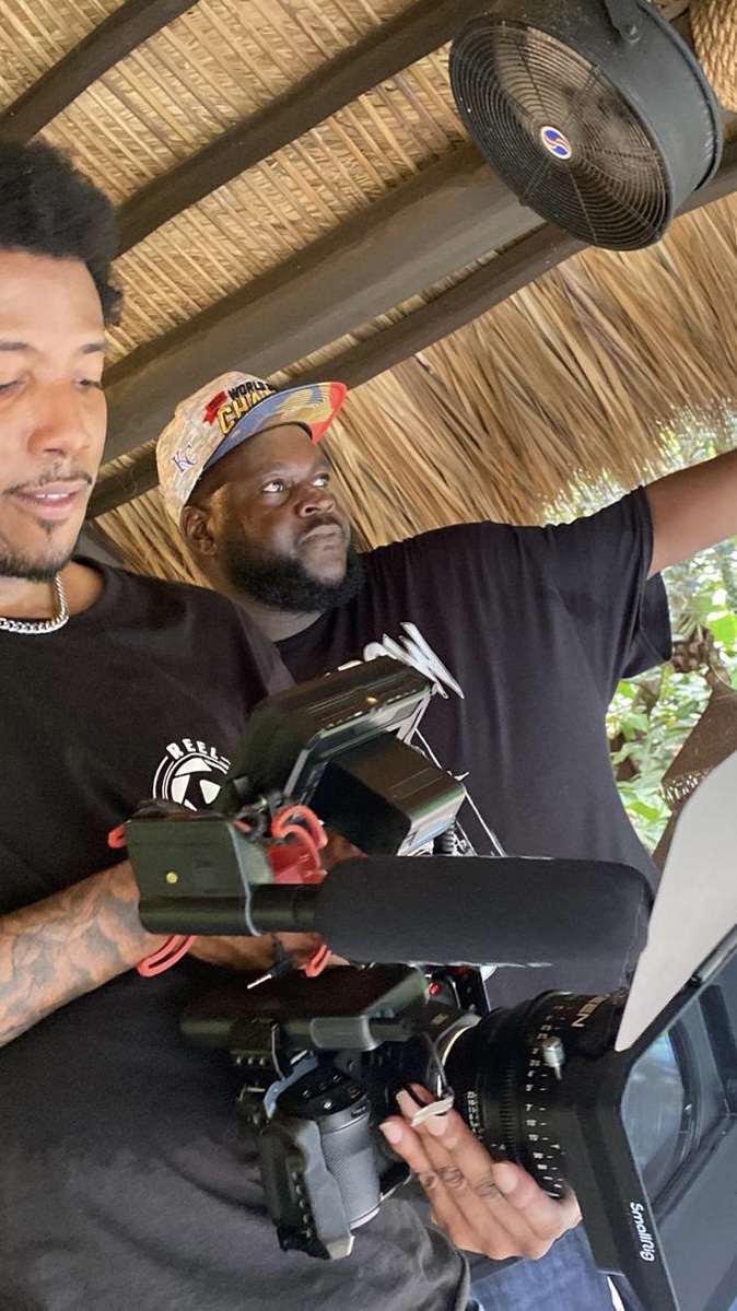 Setting up a camera rig with the team under a thatched-roof location