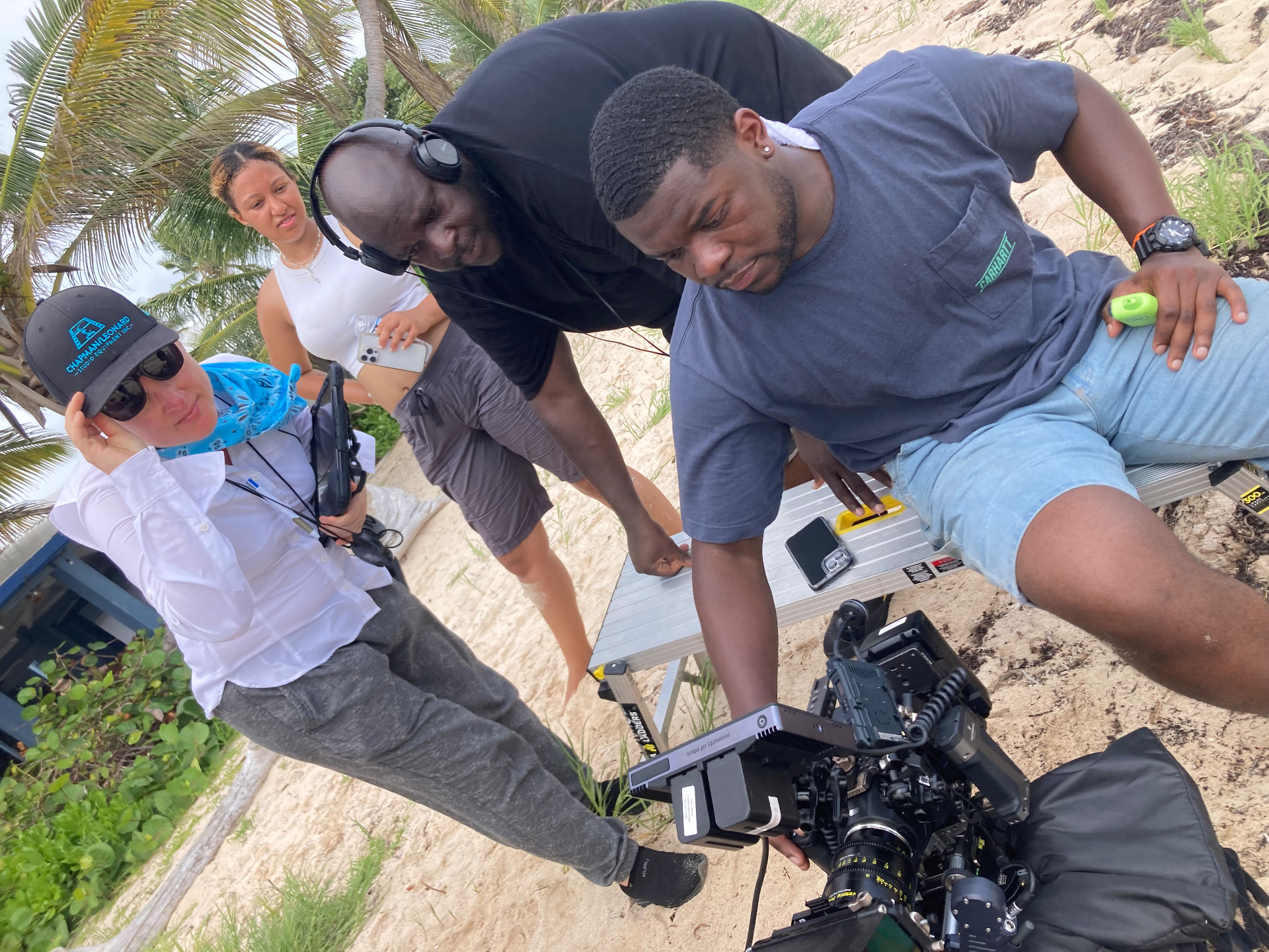 Peter Noel and a production team reviewing a cinema camera on location